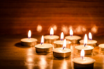 Group of handmade aroma wax candle on wooden background at night time in spa shop