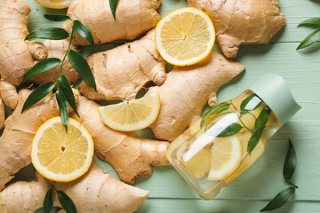 Composition with fresh ginger and lemon color wooden background
