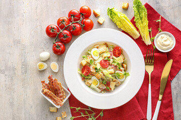 Composition with tasty Caesar salad and sauce on light background