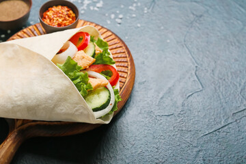 Board with tasty doner kebab on dark background, closeup