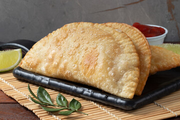 Tasting a delicious Brazilian snack pastel.