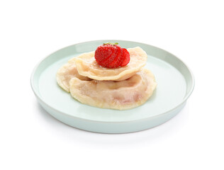 Plate with tasty dumplings and strawberry on white background