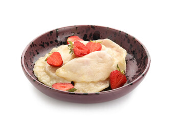 Plate with tasty dumplings and strawberry on white background