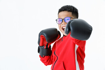 Lovely cutout portrait of young healthy Asian boy wearing red jacket, black pants, and boxer gloves standing tight and ready to fight strongly with happily smiling as enjoy boxing practice