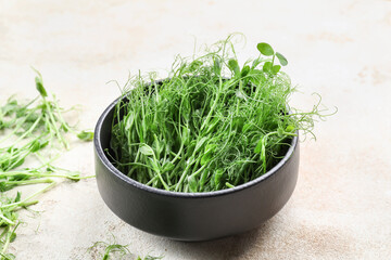 Bowl with fresh micro green on light background