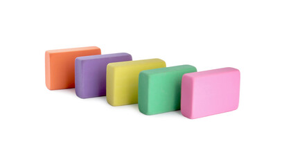 Row of bright erasers on white background