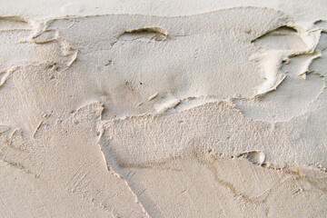 The texture of a gray concrete wall.Background of rough smears of cement on the wall.