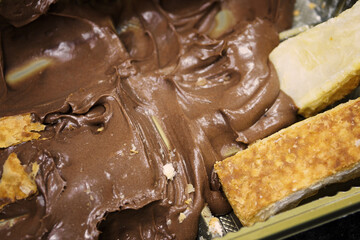 Tray with chocolate cream and puff rolls.