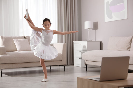 Cute Little Girl Taking Online Dance Class At Home