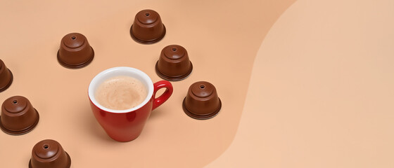 Coffee capsules and coffee cup on .beige background.