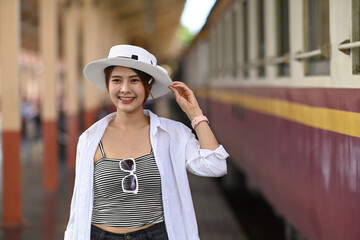 Young woman traveler walking the in the railway.