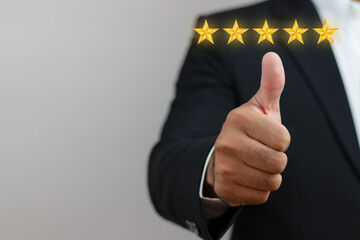 hand of businessman thumbs up with five star Satisfaction rating, financial concepts, marketing, business growth, stability, work confidence.