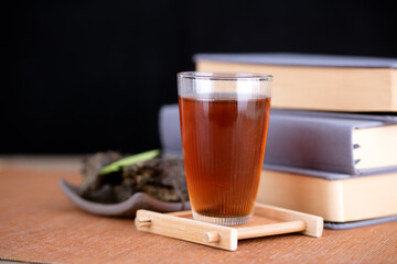 Black tea tea is next to a few books