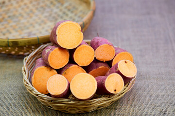 closeup cut of raw sweet potato in  wicker basket