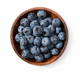 Blueberries in a wooden bowl set against a white background.