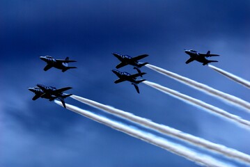 Japan Air Self Defense Force aerobatic team Blue Impulse flying in deep blue sky