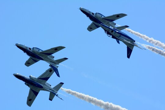 Japan Air Self Defense Force Aerobatic Team Blue Impulse Flying In Deep Blue Sky