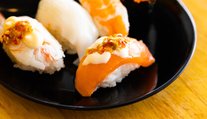 Various toppings of delicious sushi are placed on plates in Japanese restaurants. It is a very popular dish of Japan.