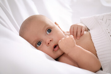 Cute little baby lying in bed, closeup