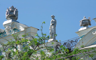 Astrakhan, Russia. 07.07.20. Plaster sculptures on the roof of a building in a Russian city.