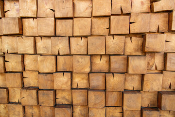 Wooden, textured wall lined with wooden cubes, longitudinal cuts of a fir tree.