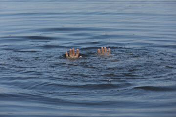 Fototapeta premium Drowning man reaching for help in sea, closeup