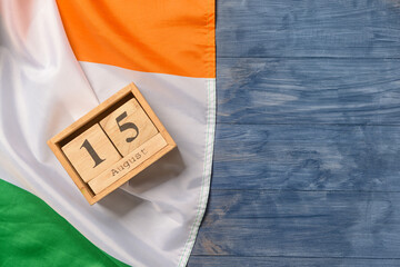 Indian flag and calendar with date 15 August on wooden background. Independence Day celebration