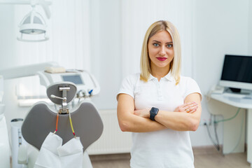 Portrait of professional dentist in white hospital ward. Young medical practitioner.