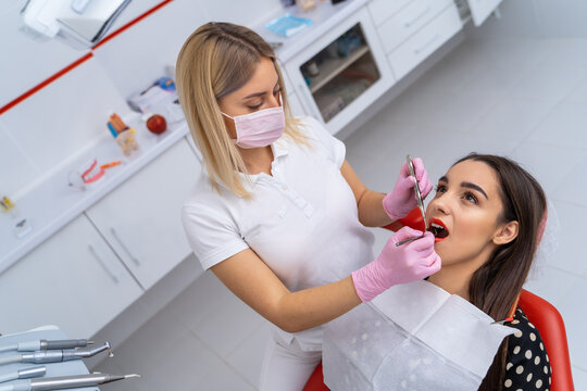 Professional doctor dentist working with petient teeth. Stomatology dental hospital.