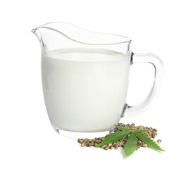 Glass jug with fresh hemp milk, seeds and leaf on white background