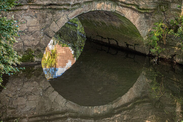 old stone bridge and reflection 