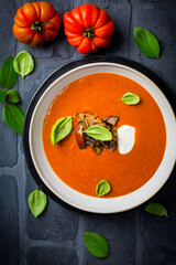 Homemade tomato soup with roasted eggplant and basil