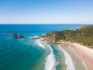 An aerial view of Broken Head Beach and headland