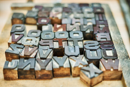 Collection of metal letters and numbers in wooden box