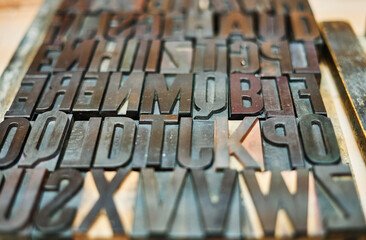 Collection of metal letters and numbers in wooden box
