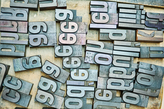 Collection of metal letters in wooden box