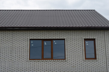 Brown windows on a white brick wall.