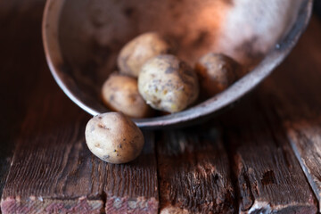 Fresh vegetables close-up on a wooden table. Onions, potatoes, garlic