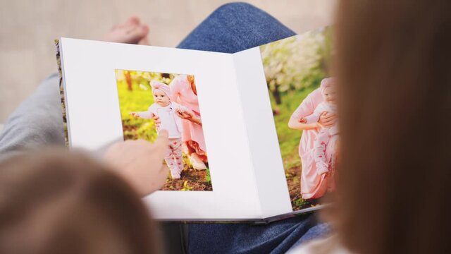 top view.mother and daughter watch photobook family photo shoot in spring garden