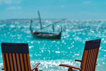 Fototapeta premium Two chairs on the background of indian ocean