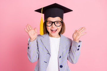 Photo of impressed little girl hands up wear eyewear striped blazer cap isolated on pink color...