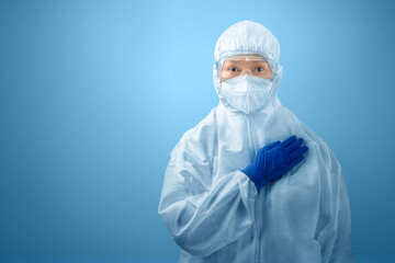 Health worker woman with a protective suit and gloves standing