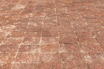 Brown laterite stone floor outside the building at the ancient site