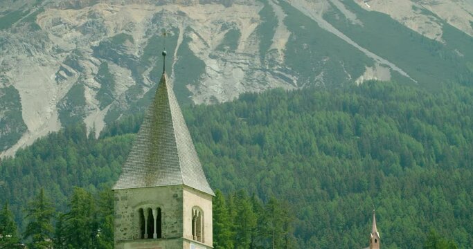 Focus Shot, Scenic view of top of Church tower in Italy, Rocky mountain range of Melcesine in the background.