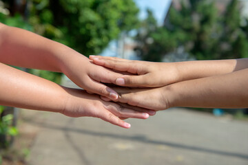 Human hand holding another hand