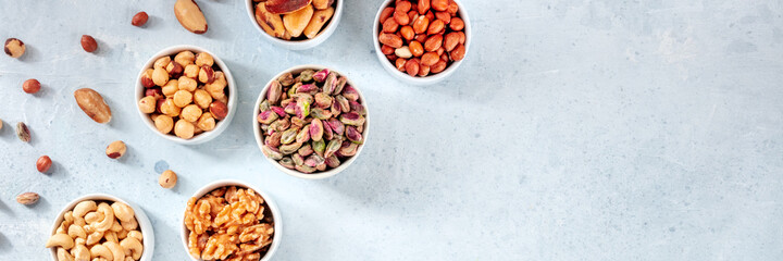Nuts panorama with a place for text or logo, top shot. Pistachios, walnuts and many other nuts