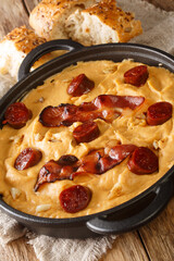 Gachas manchegas with bacon and chorizo Delicious simple Spanish food close-up in a pan on the table. Vertical