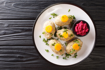 Gefilte Fish Boiled fishballs served with horseradish and carrots close-up in a plate on the table. horizontal top view from above