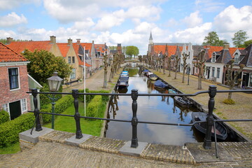 Fototapeta na wymiar The historical center of Sloten, Friesland, Netherlands, with historical houses, canals, boats, cobbled walkways and bridges