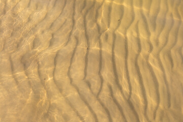 Fototapeta na wymiar yellow sand under the water and the sun